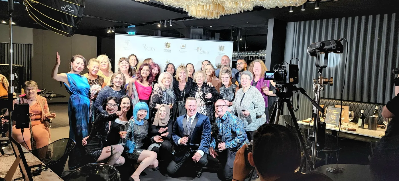 Remi and a large group posing together at an event